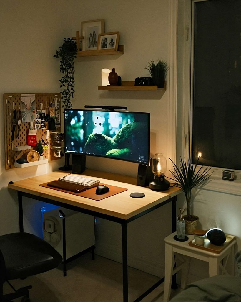 This cozy corner gaming setup is a good example of how shelving and wall coverage can really bring a smaller space together. The wooden desk ties together with the wrist rest and mousepad, and the abundance of plants (real or fake) is a nice touch that matches with the wood too. 